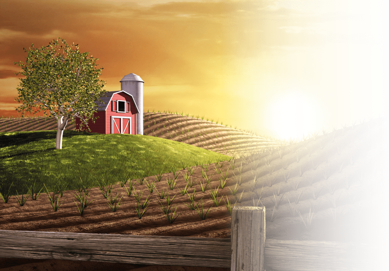 Red barn and tractor on a farm with the sun rising over the horizon