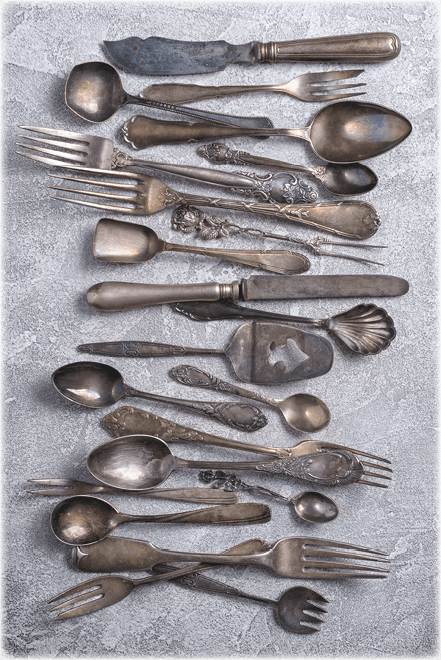 Top view of vintage silver cutlery or silverware on grey concrete background